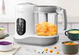 a baby food maker on a counter with bowls of baby food