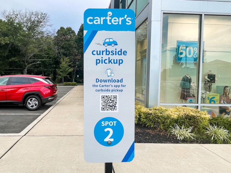 A Carter's online order curbside pickup sign outside of the store.