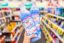 person holding 2 suavitel fabric softeners in an aisle
