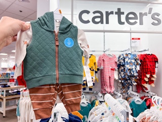 hand holding up clearance carter's sweater vest outfit at jcpenney