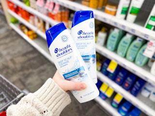 person holding 2 bottles of head and shoulders shampoo