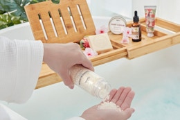 a woman using a bath gift set