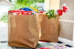 two brown paper bags filled with groceries and school supplies on a doorstep delivered by instacart