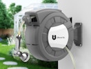 a retractable hose reel on the outside of a house