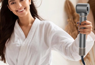 a person using a hot air hair styler 