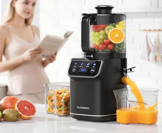 a juicer juicing grapefruits on a counter