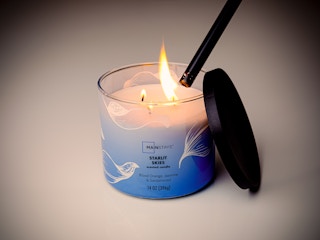 Walmart candle being lit with a lighter