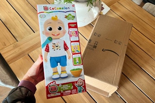 hand holding cocomelon doll