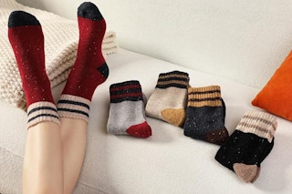 woman wearing socks next to folded pairs
