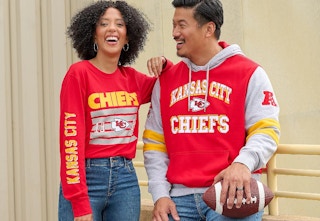 Couple wearing a NFL hoodie and long sleeve tee