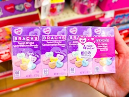 hand holding a pack of brachs conversation hearts