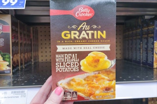 hand holding a box of betty crocker au gratin potatoes at kroger