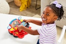 Lifestyle image of child playing with the Vtech Paw Patrol Rescue Driver ATV & Fire Truck Toy