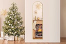 Lifestyle image of the EDX Arched Full Length Mirror in the color gold (Christmas tree in the background)