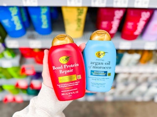 OGX Shampoo & Conditioner held up in hair care aisle in Walmart store