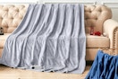 heated throw blanket draped across couch