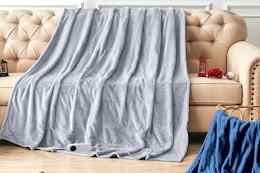 heated throw blanket draped across couch