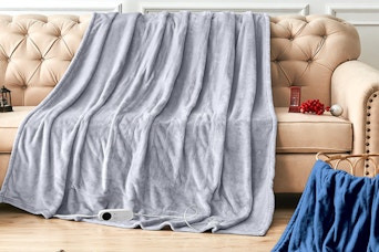 heated throw blanket draped across couch