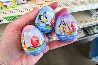 person holding 3 bluey bath bombs