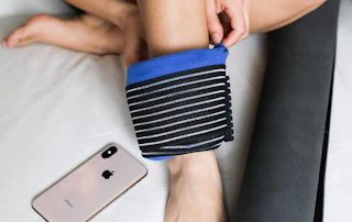 an ice therapy wrap around a person's ankle 