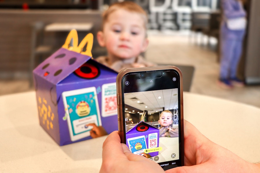 a person scanning a QR code on a happy meal