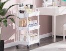 a rolling cart full of beauty products