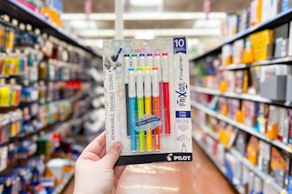 person holding a 10-pack of pens