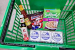 A1 sauce, hot sauce, snickers, suddenly salad, and klondike bars in a green basket