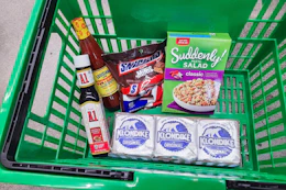 A1 sauce, hot sauce, snickers, suddenly salad, and klondike bars in a green basket
