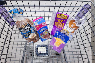 protein bread, snack bags, 67 chicken nuggets, sliced cheese, and blueberries in a cart