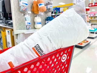 room essentials body pillow sitting in a target cart