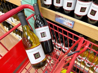 charles shaw two-buck chuck wine bottles in cart