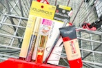 l'oreal foundation, mascara, lipstick, and eyeliner in a cart