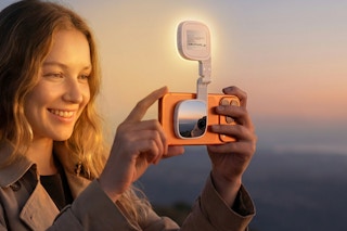 Woman using the  ATDIAG Magnetic Selfie Light outdoors in the evening.
