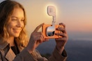 Woman using the ATDIAG Magnetic Selfie Light outdoors in the evening.