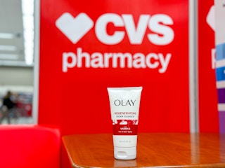 olay cleanser on a shelf by a cvs sign