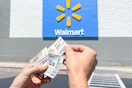 someone holding coupons outside of walmart