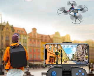 drone in the air with camera recording and control visible