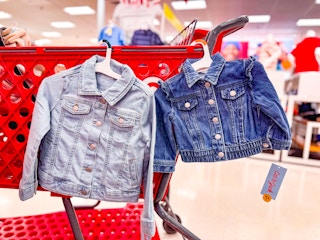 2 toddler jackets sitting on a target cart