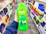 hand holding pert shampoo and conditioner in cvs