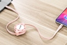 iPhone plugged into a Retractable USB C cord on a desk.