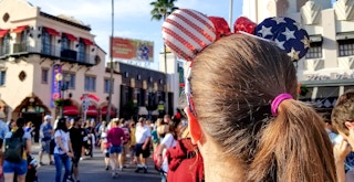 A person wearing minnie mouse ears with stars and stripes on them