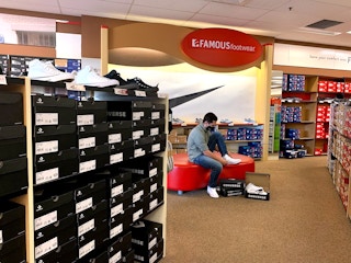 Man trying on shoes in famous footwear