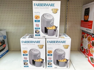 three air fryers stacked on a shelf at Walmart