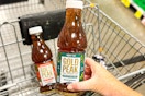 hand holding a bottle of gold peak tea