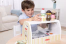 lifestyle image of a child playing with a melissa & doug ice cream playset