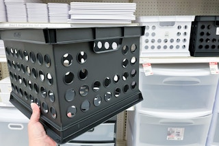 hand holding a room essentials milk crate at target