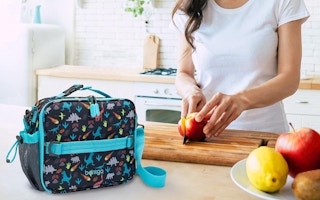 woman cutting apple near Bentgo lunch bag