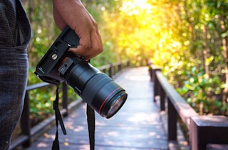 someone using a camera to take photos outdoors