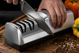 a man using an electric knife sharpener